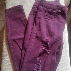 Distressed stretch jean in burgundy...